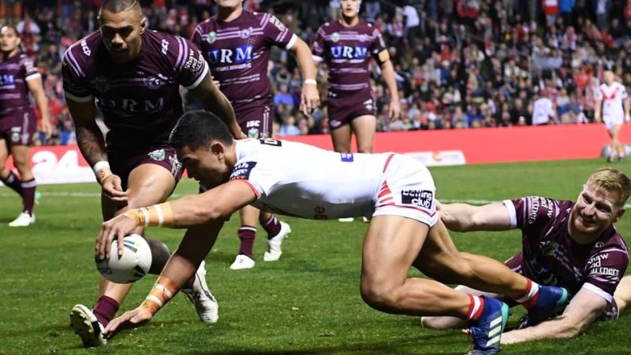 Timoteo Lafai of the Dragons scores a try.