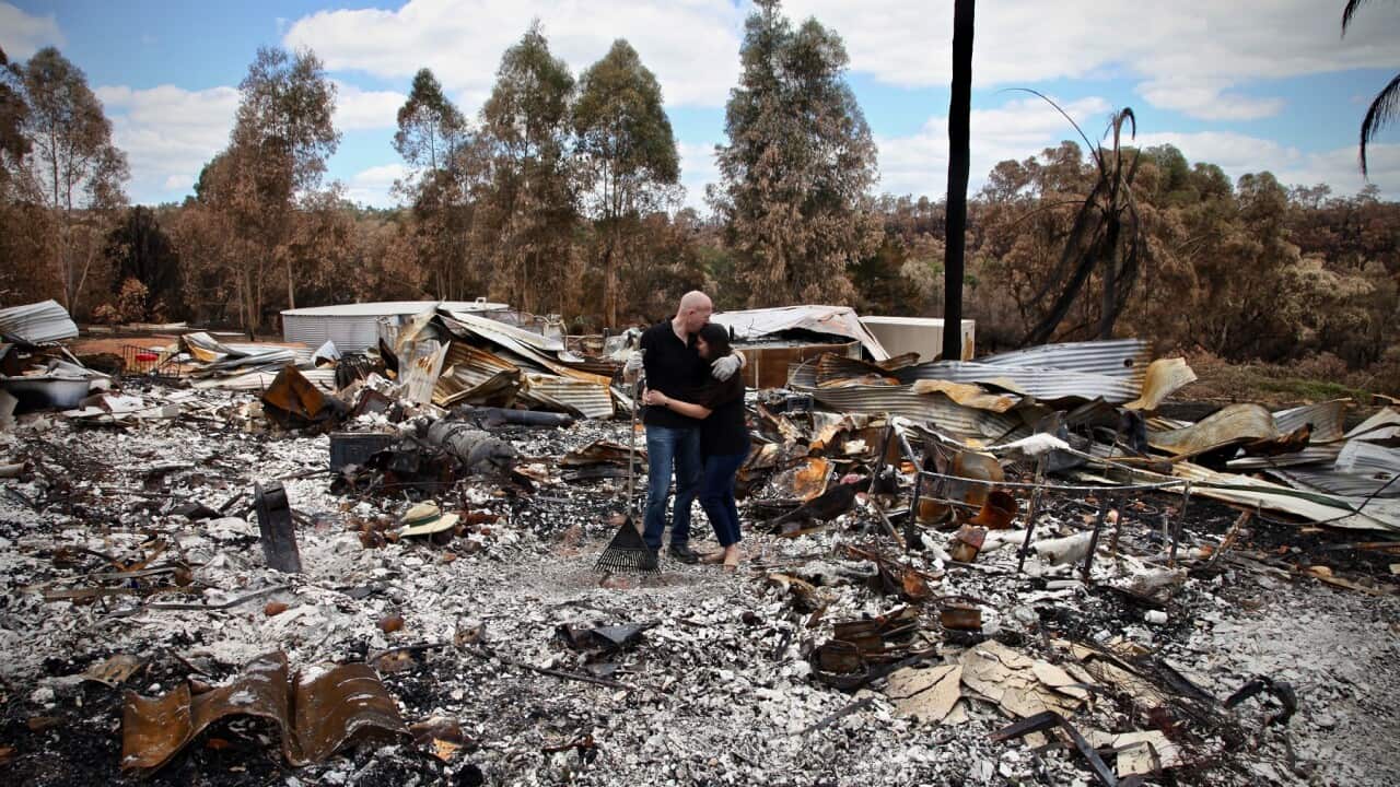 Clint Maher and Tamara Blake in the remains of their home