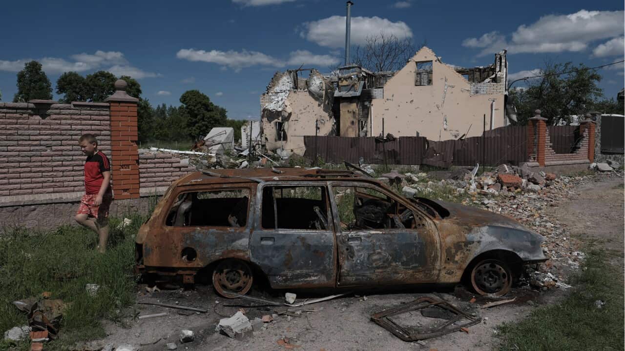 Severely destroyed buildings and a car are left in the suburbs of Kyiv on June 3, 2022, marking 100 days of the invasion