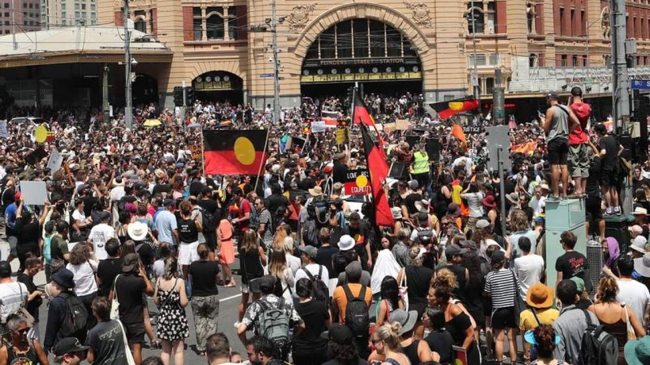 Invasion day protesters outside Flinders St station in Melbourne.