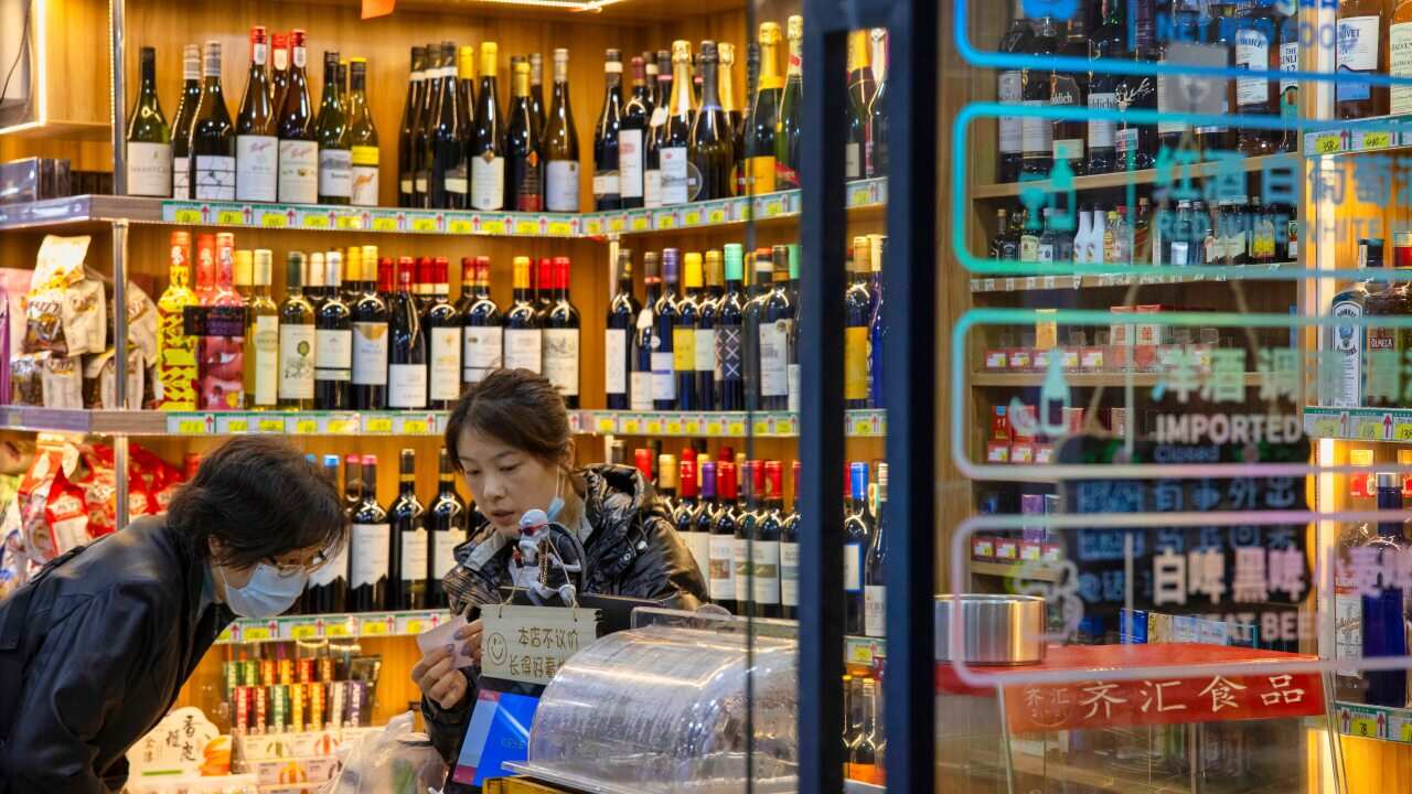 A woman shops at an imported food and wine shop in Shanghai, China, on 27 November.