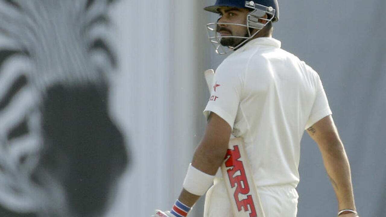 India's Virat Kohli walks off the field of play after losing his wicket