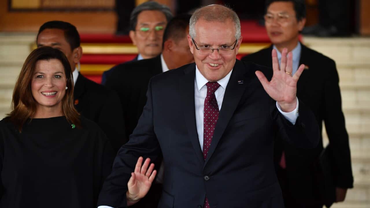 Prime Minister Scott Morrison (R) and his wife Jenny (L) after the inauguration ceremony of Indonesia President Joko Widodo.