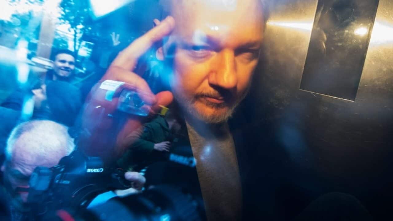 Julian Assange, in a prison van, as he leaves Southwark Crown Court.