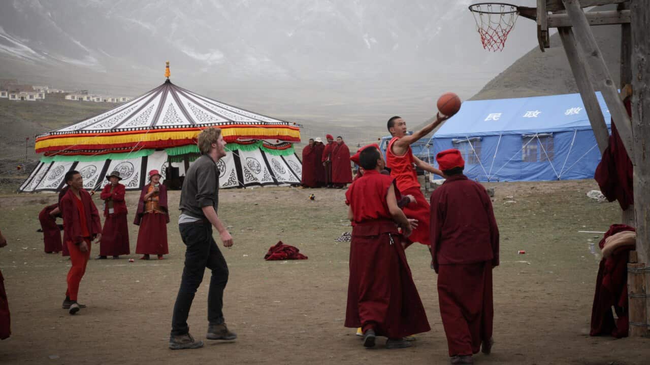 Video journalist Ryan Jasper plays basketball with a group of Tibetan monks.