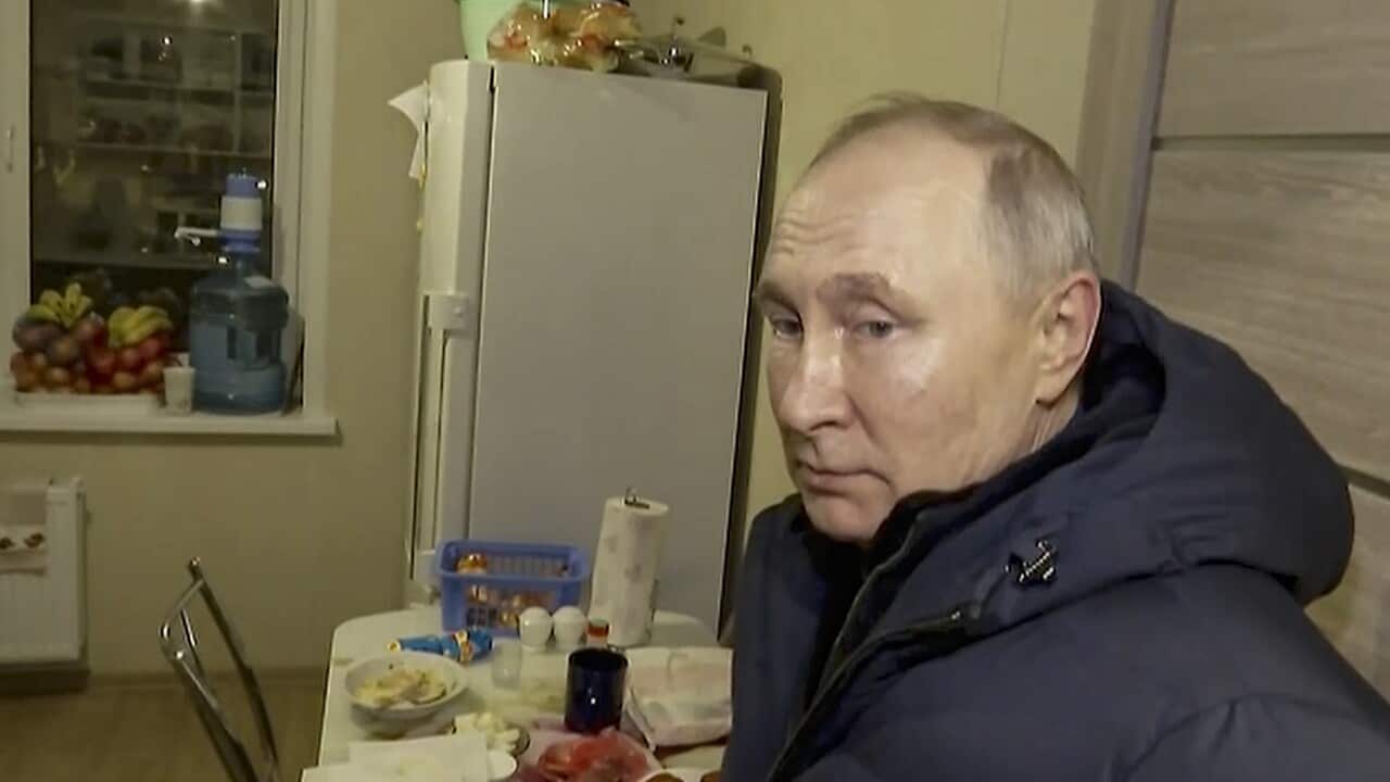 Vladimir Putin sits in home.