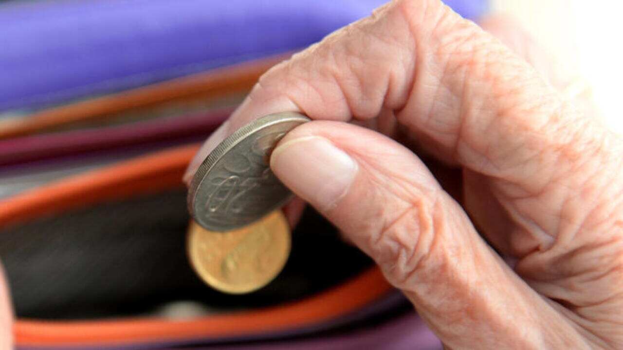 Money is taken out of a purse Canberra, April 8, 2014. Aged pensions are expected to be hit in the upcoming 2014 budget. (AAP Image/Alan Porritt) NO ARCHIVING