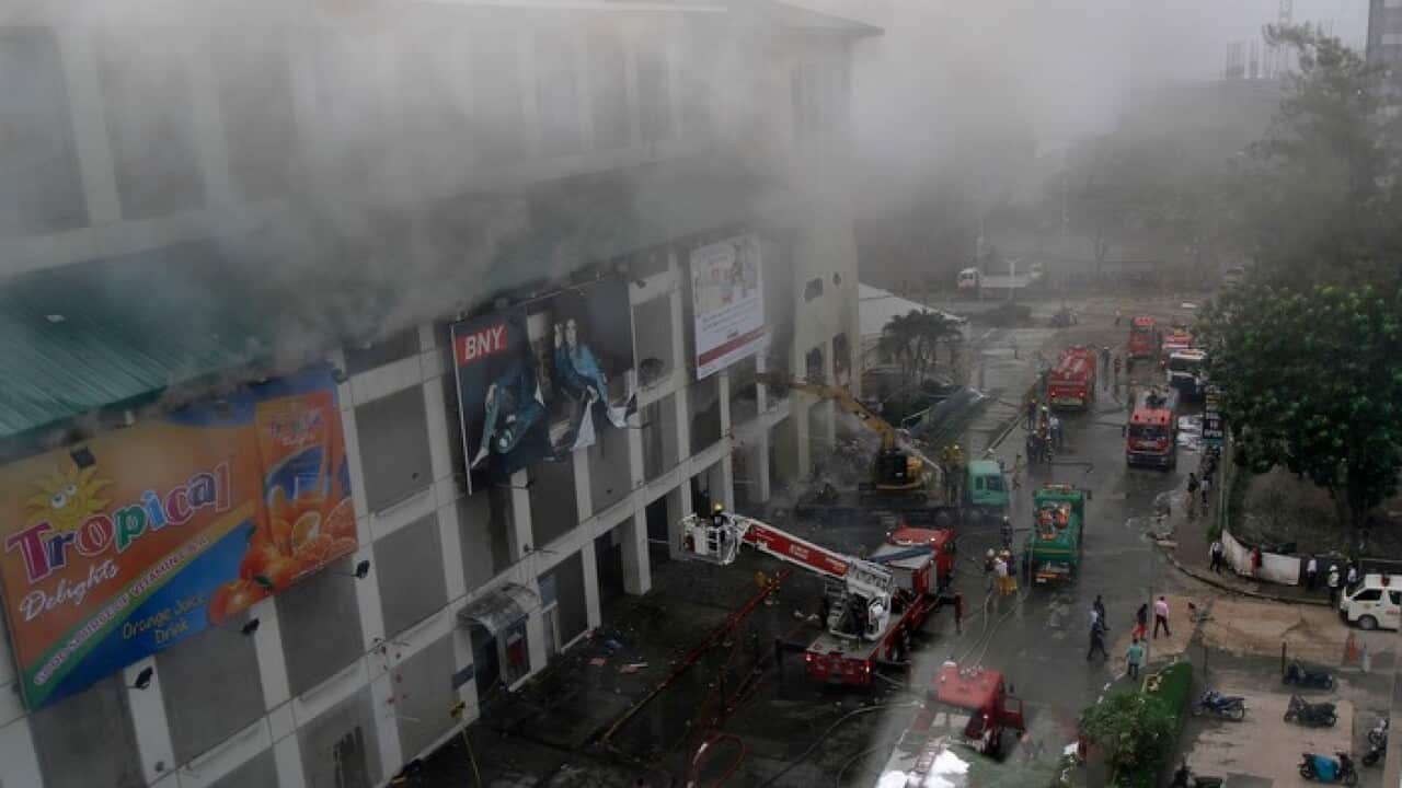 Smoke billows from a burning shopping mall in Cebu City