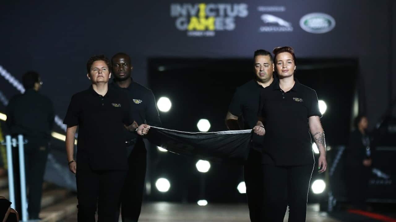 The official flag is carried during the Invictus Games opening ceremony in Sydney.