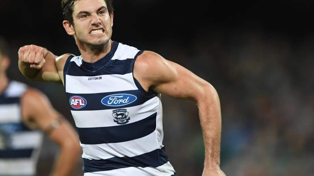 Daniel Menzel of the Cats reacts after kicking a goal