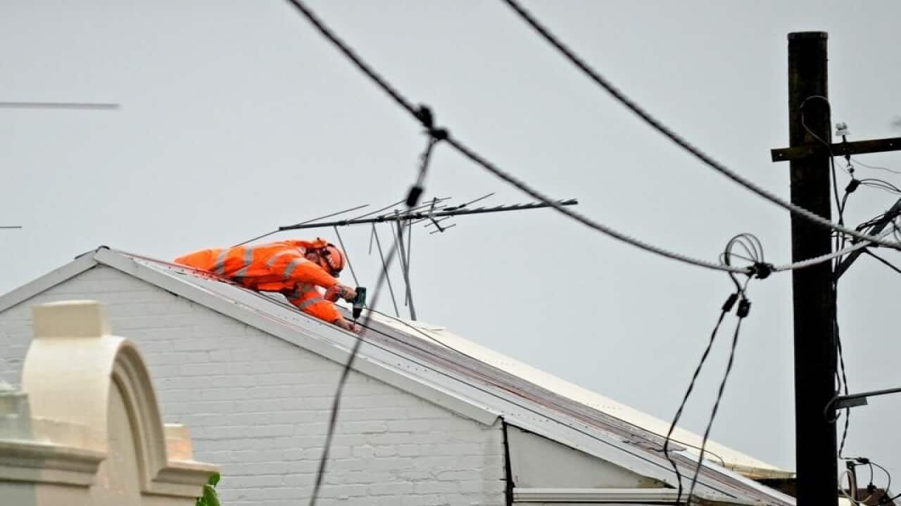 A file image of SES crew work to repair a damaged roof