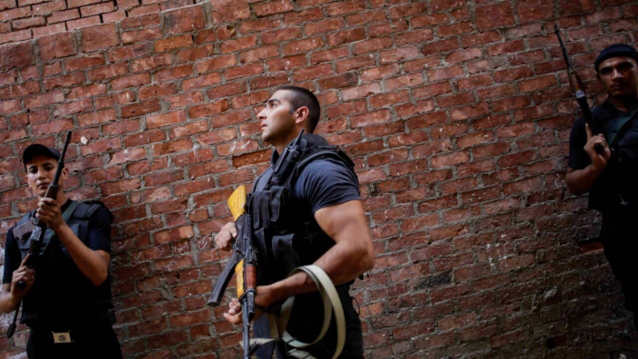 Egyptian security forces stand guard in Giza, south of Cairo, Egypt.