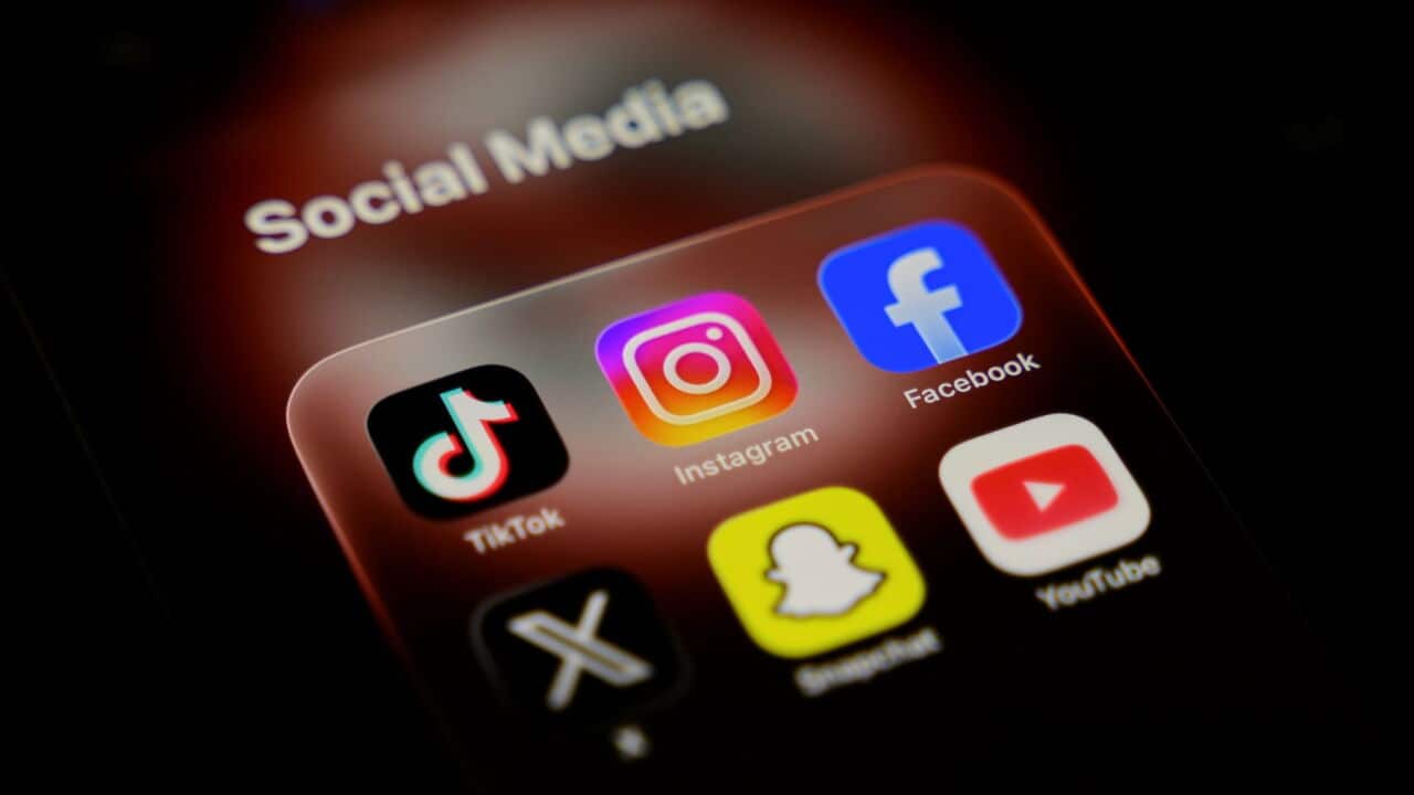 A smartphone displays a folder of social media applications, including TikTok, Instagram, Facebook, X, Snapchat, and YouTube (Samuel Boivin-NurPhoto via Getty Images).jpg