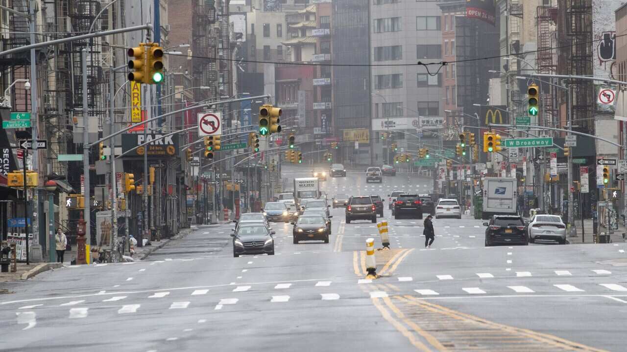 Pedestrians and traffic are seen on Canal Street Sunday, March 29, 2020, in New York. (AP Photo/Mary Altaffer)