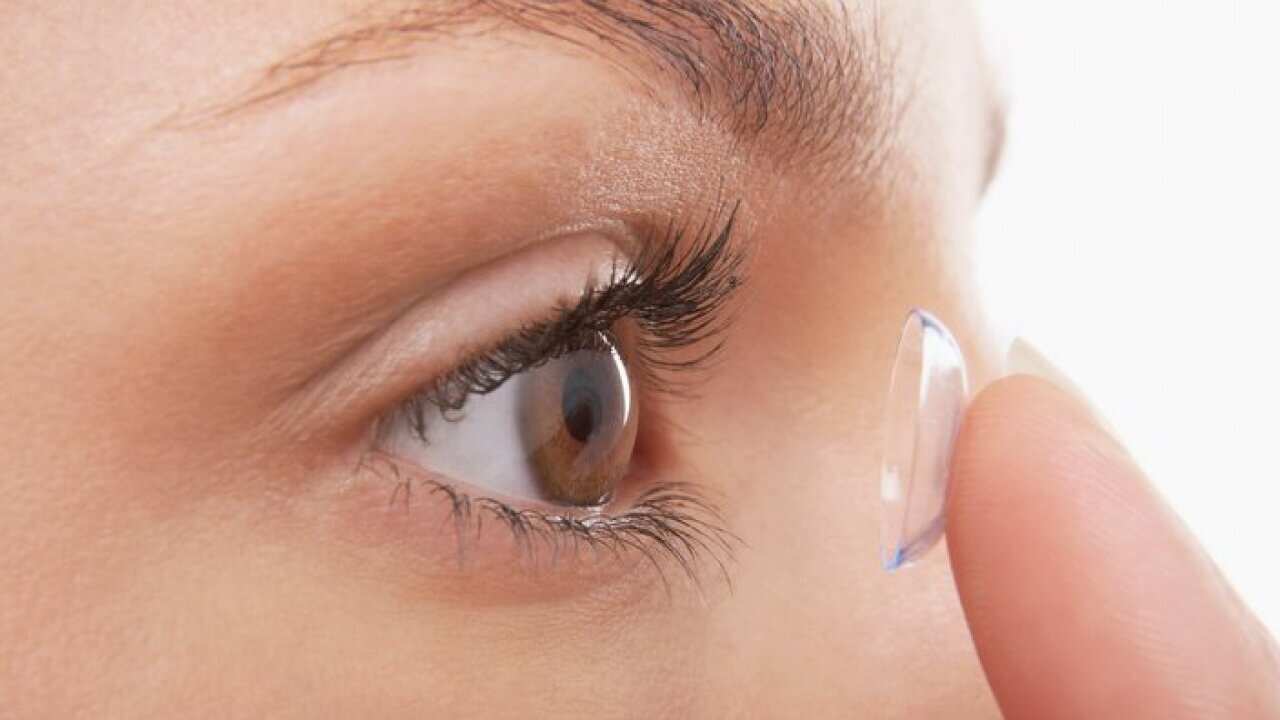 Young Woman Putting in Contact Lens