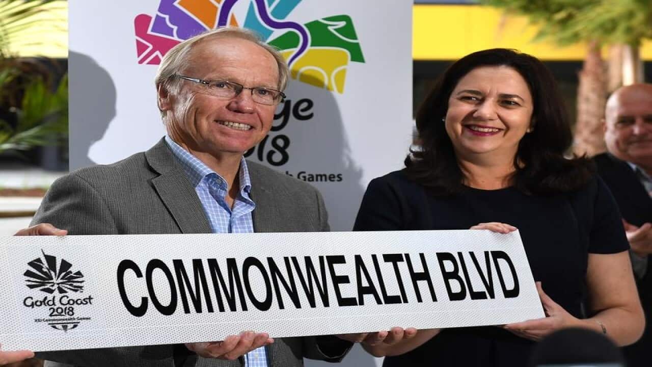 GOLDOC head Peter Beattie and Annastacia Palaszczuk with a Games sign.