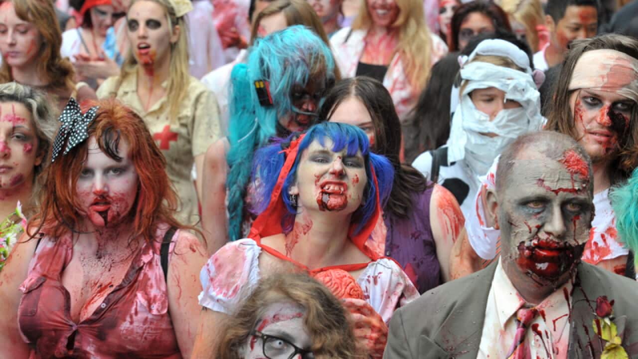 People dressed as zombies participate in a Zombie Walk