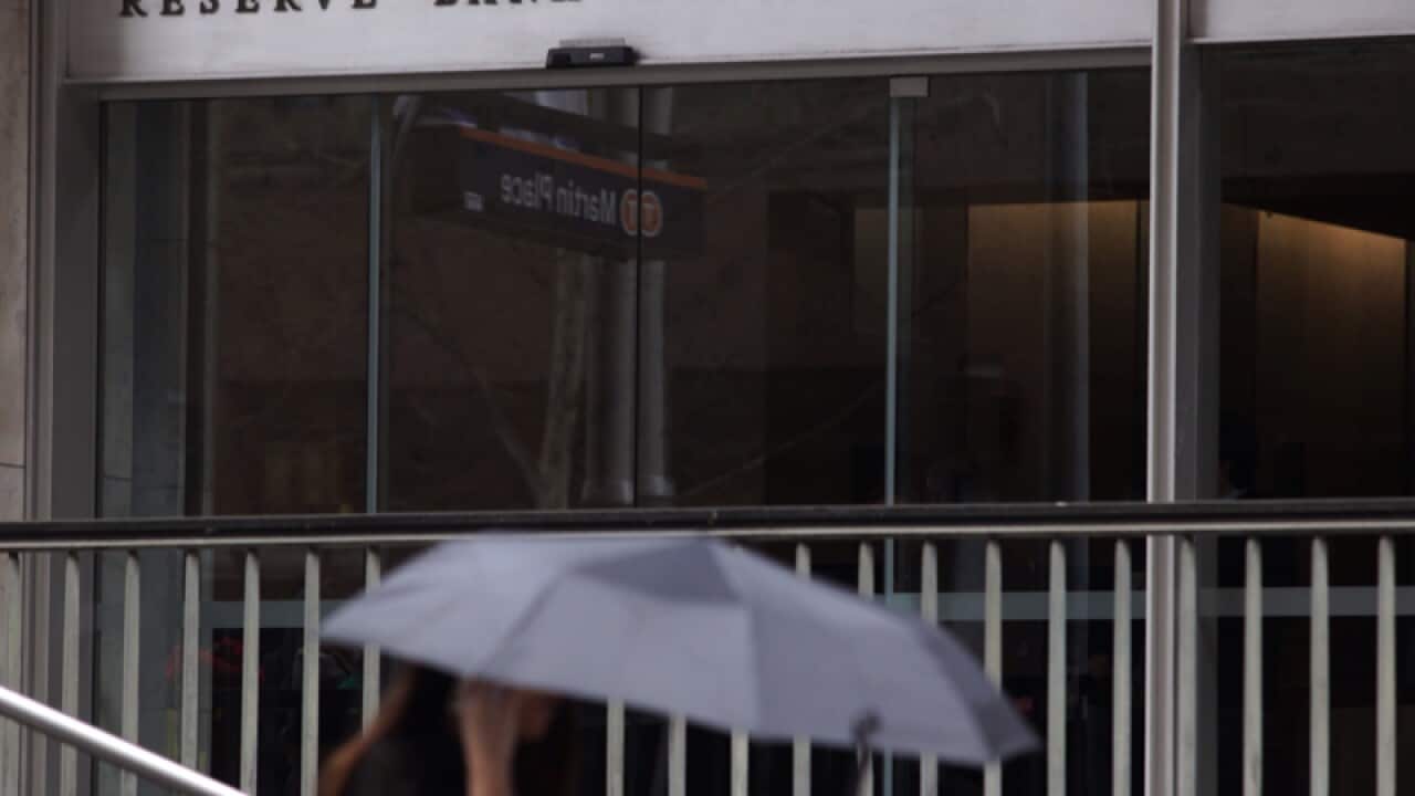 A pedestrian walks past the Reserve Bank of Australia head office