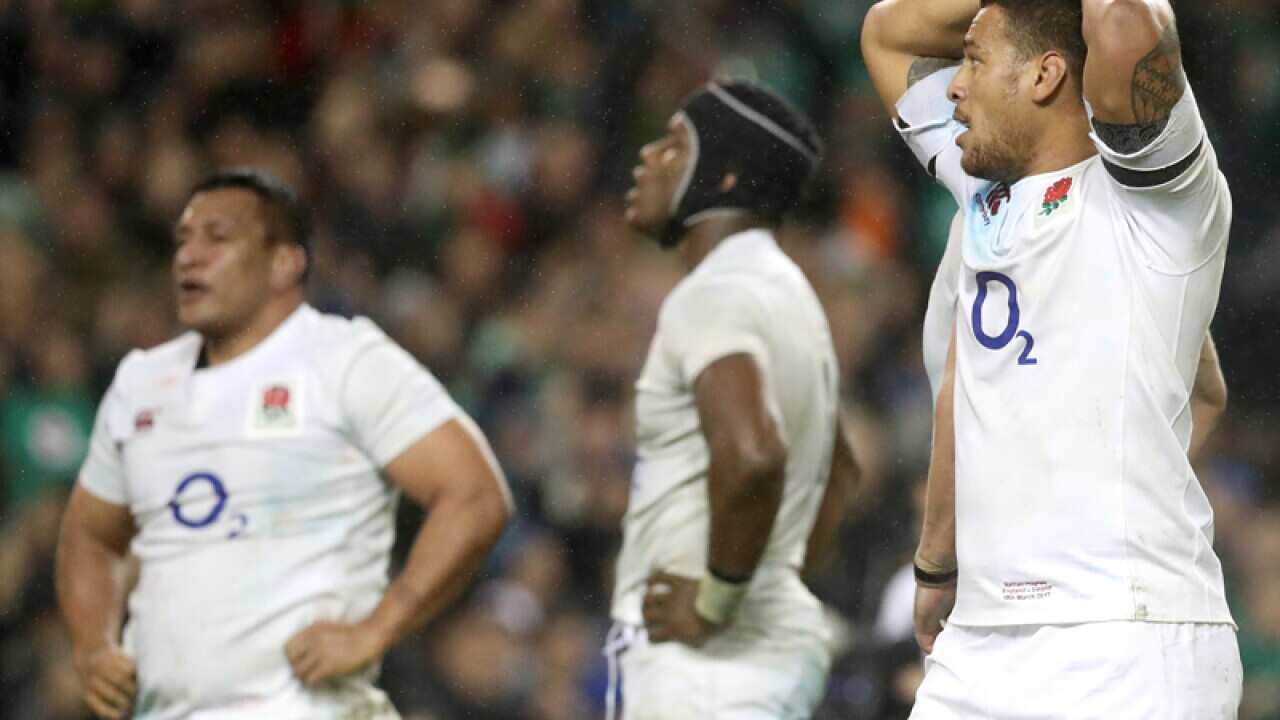 England's Nathan Hughes (R) stands dejected