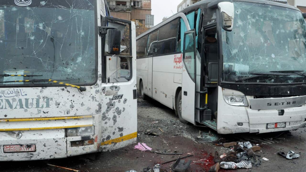 Damaged buses at the site of bombing, in Damascus
