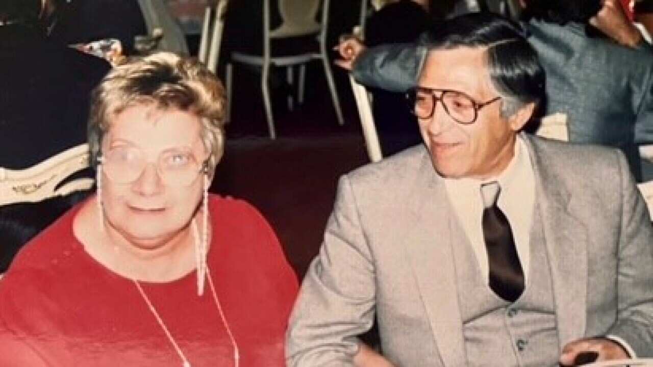 Aldo Reggiani with his wife sitting at the table.