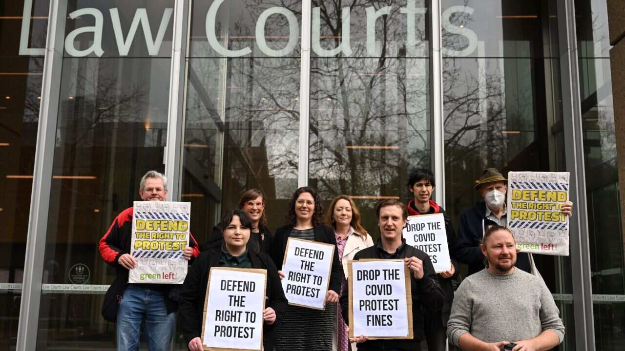 A small group of protesters gather outside the Supreme Court during a pre-hearing media conference on cases to be heard in the NSW Supreme Court challenging fines issued by NSW Police to protesters under COVID-19 Public Health Orders, at the Supreme Court of New South Wales in Sydney, Thursday, September 1, 2022.
