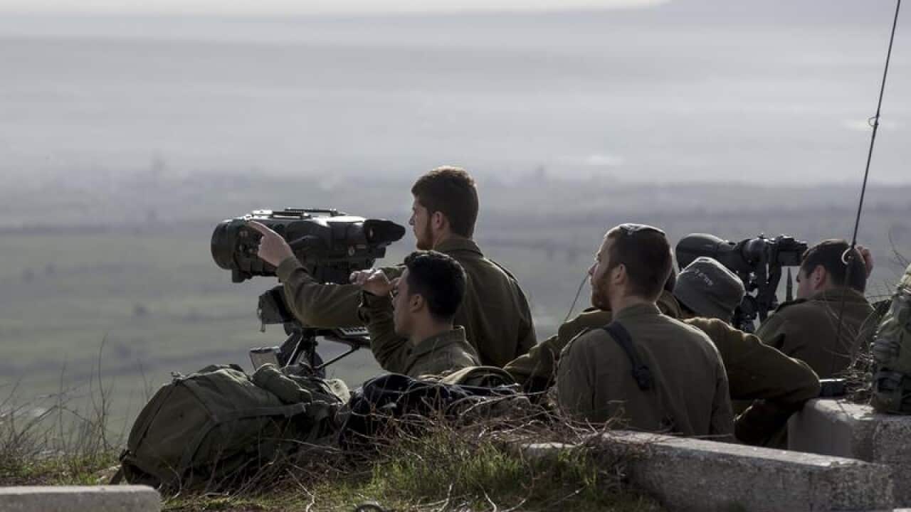 Israeli soldiers taking positions next to the Israeli-Syrian border