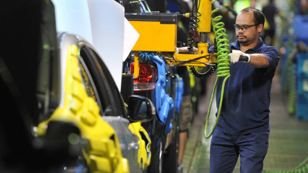 New cars rolling along the assembly line.