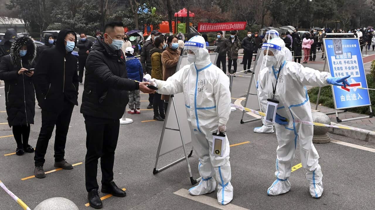 People line up for COVID-19 tests in Xi'an in northwestern China's Shaanxi Province