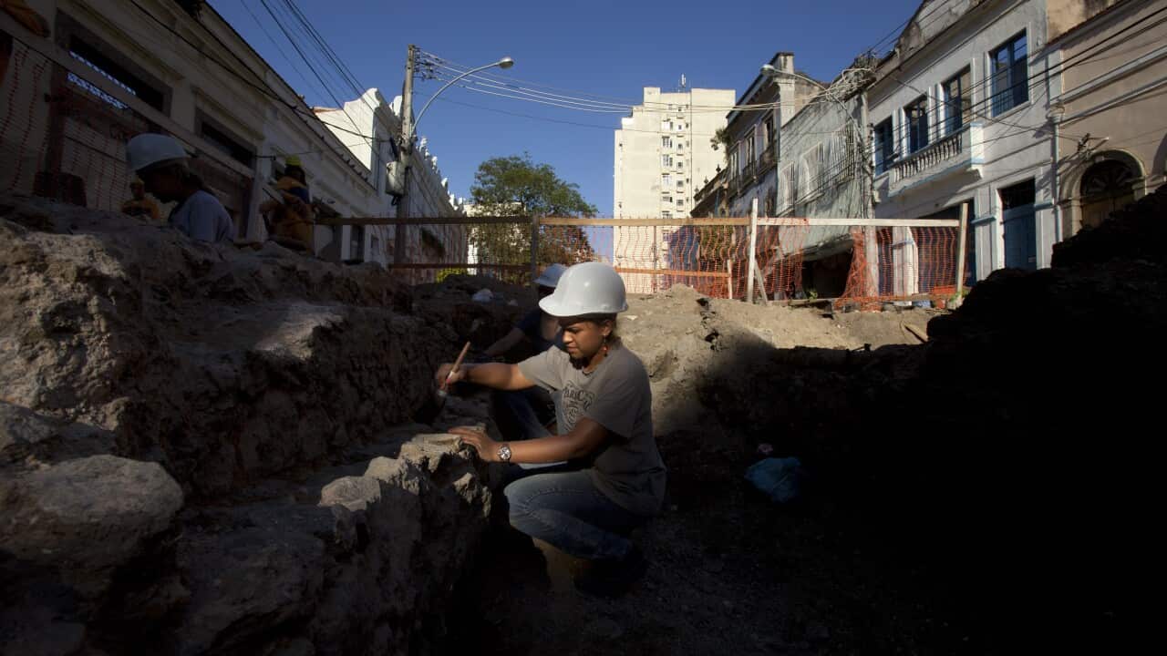 (File Image) A student works on excavating ruins from the 1800s in the port area of Rio de Janeiro in March 2012.