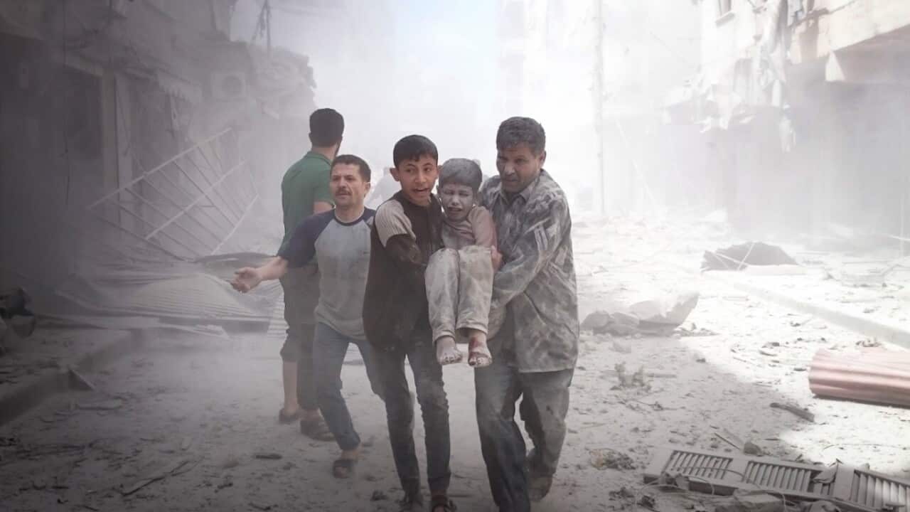 People carry an injured boy after Russian forces staged air-strike over Aleppo's opposition controlled Sukkeri region, Syria on April 28, 2016.(Getty)