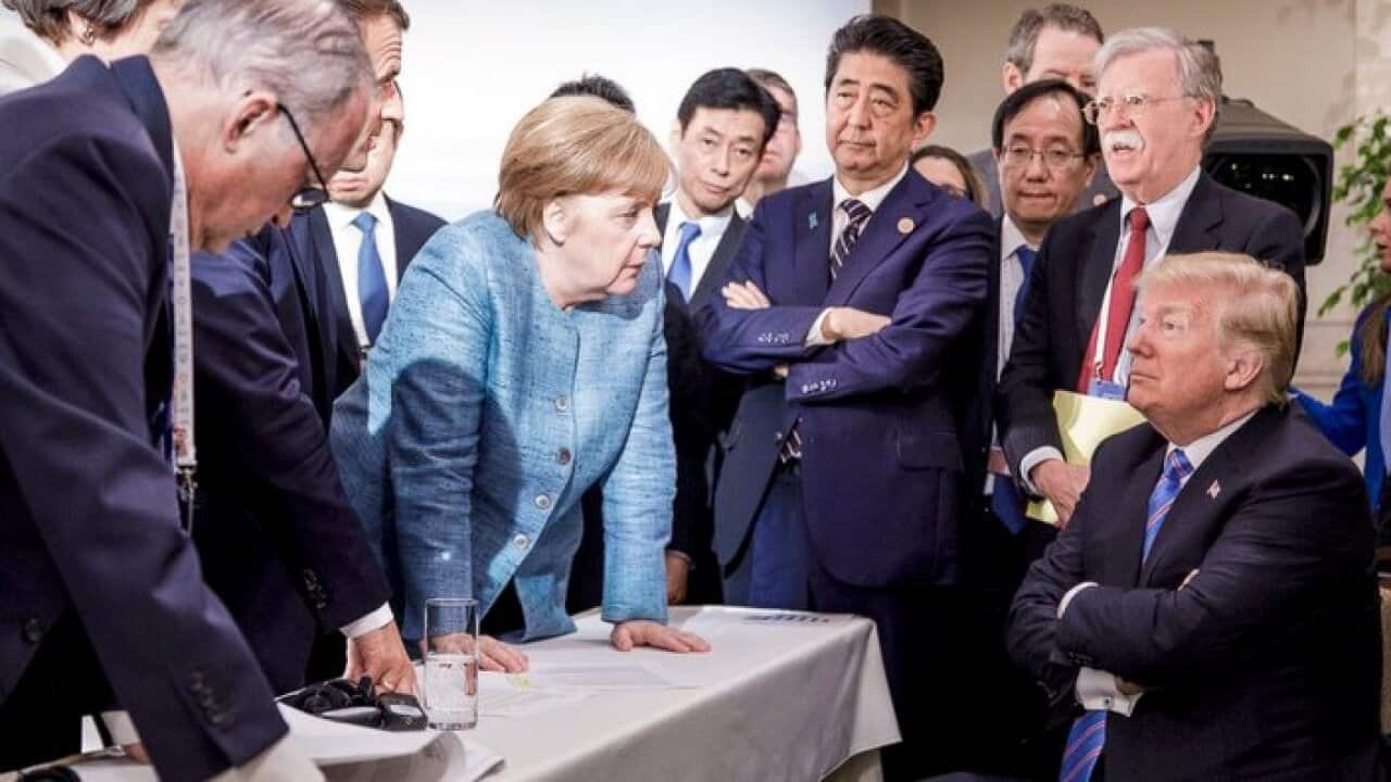 In this photo made available by the German Federal Government, German Chancellor Merkel, center, speaks with U.S. President Donald Trumpduring the G7 Summit.