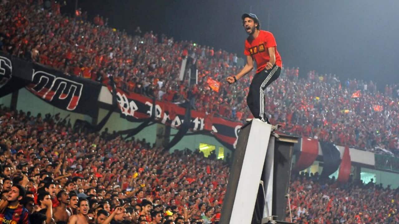 Fans of Al-Ahly cheer for their team during the Egyptian League football match against rival club Zamalek in Cairo