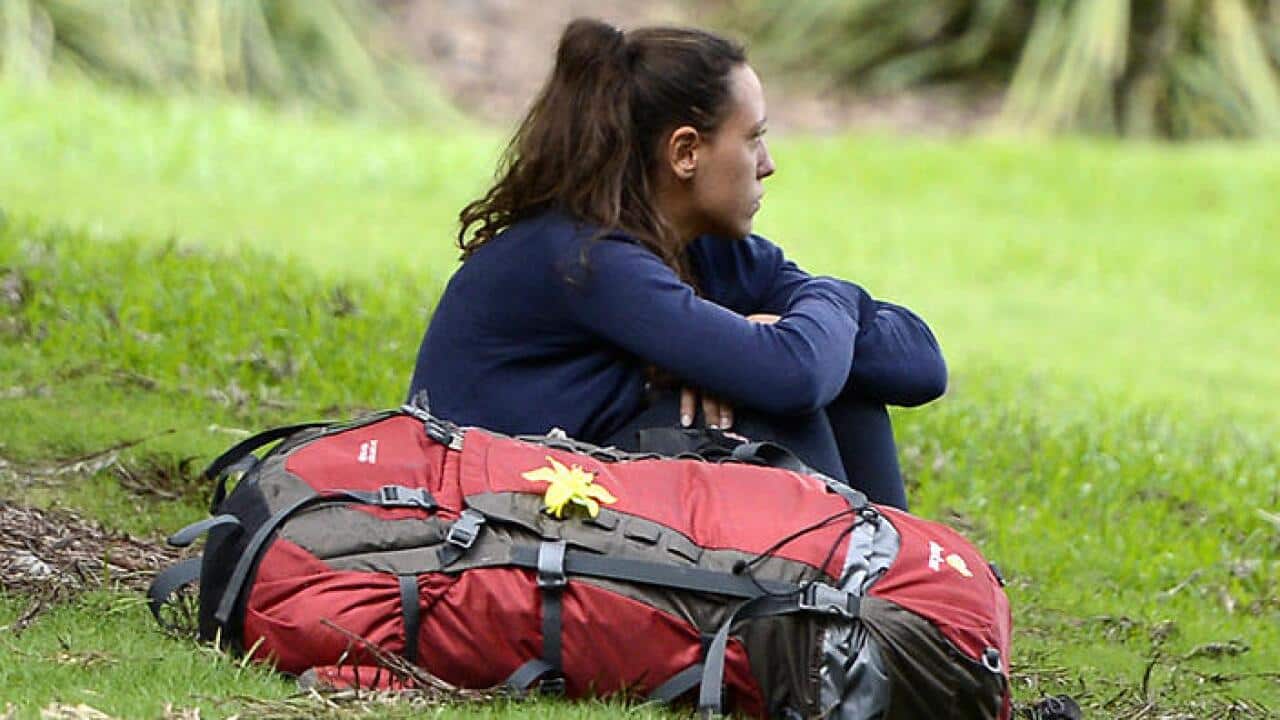 A backpacker sits in a park Brisbane, Wednesday, April 3, 2013. (AAP Image/Dan Peled) NO ARCHIVING