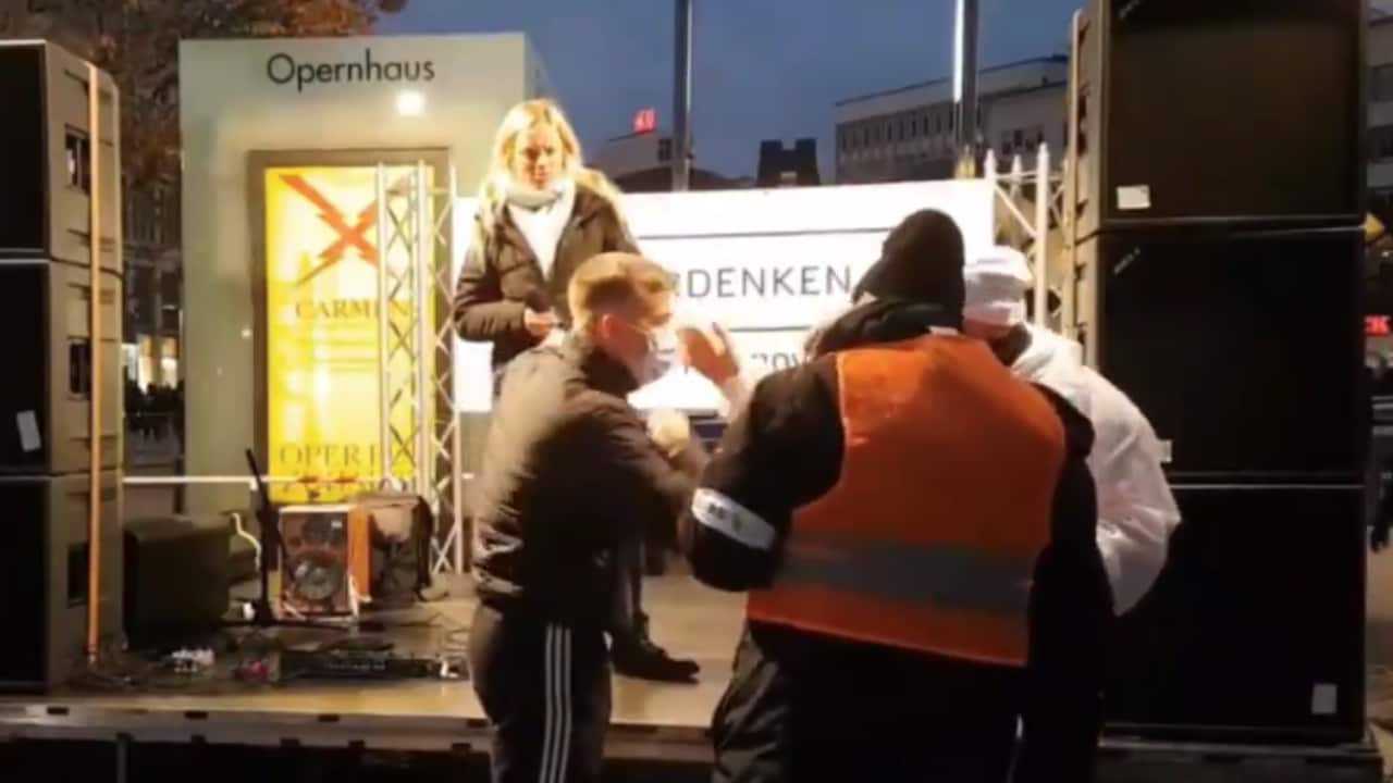 The protester was confronted by a steward in Hanover after saying she felt "just like Sophie Scholl", the German student executed by the Nazis in 1943.