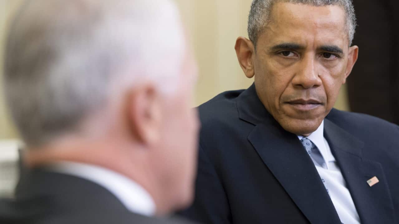 Barack Obama (R) listens to Malcolm Turnbull
