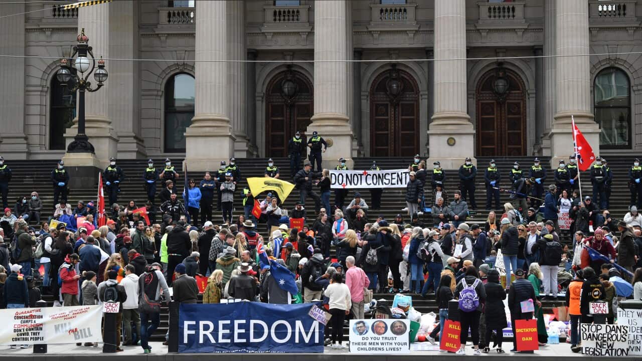 People are seen during a demonstration outside the Victorian State Parliament in Melbourne, Tuesday, November 16, 2021.