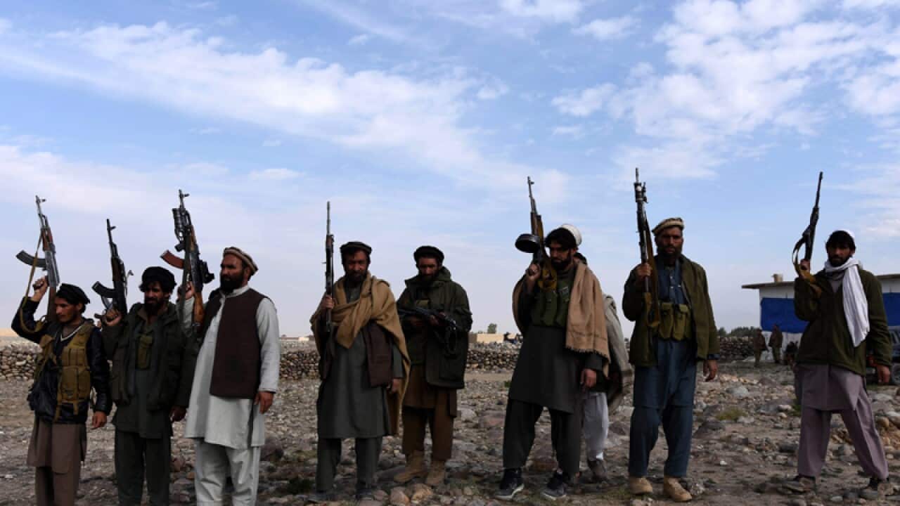 Pro-government forces stand guard at a check post, Afghanistan
