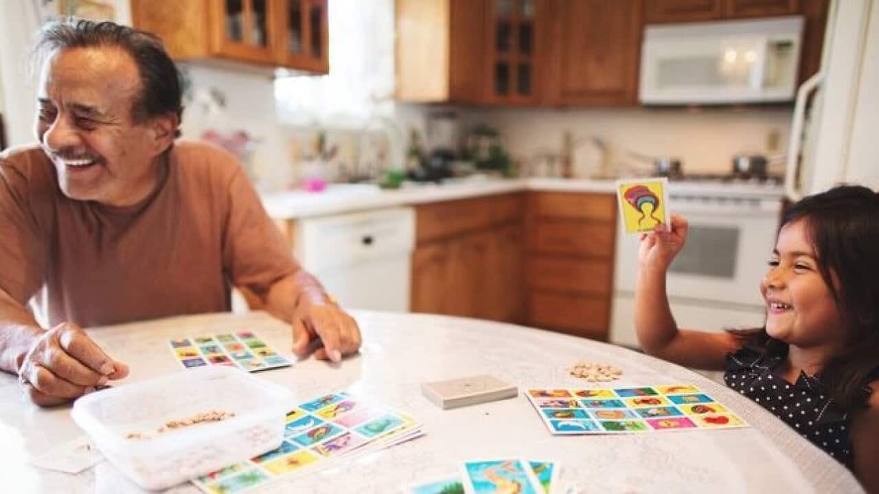 Family plays board game credit