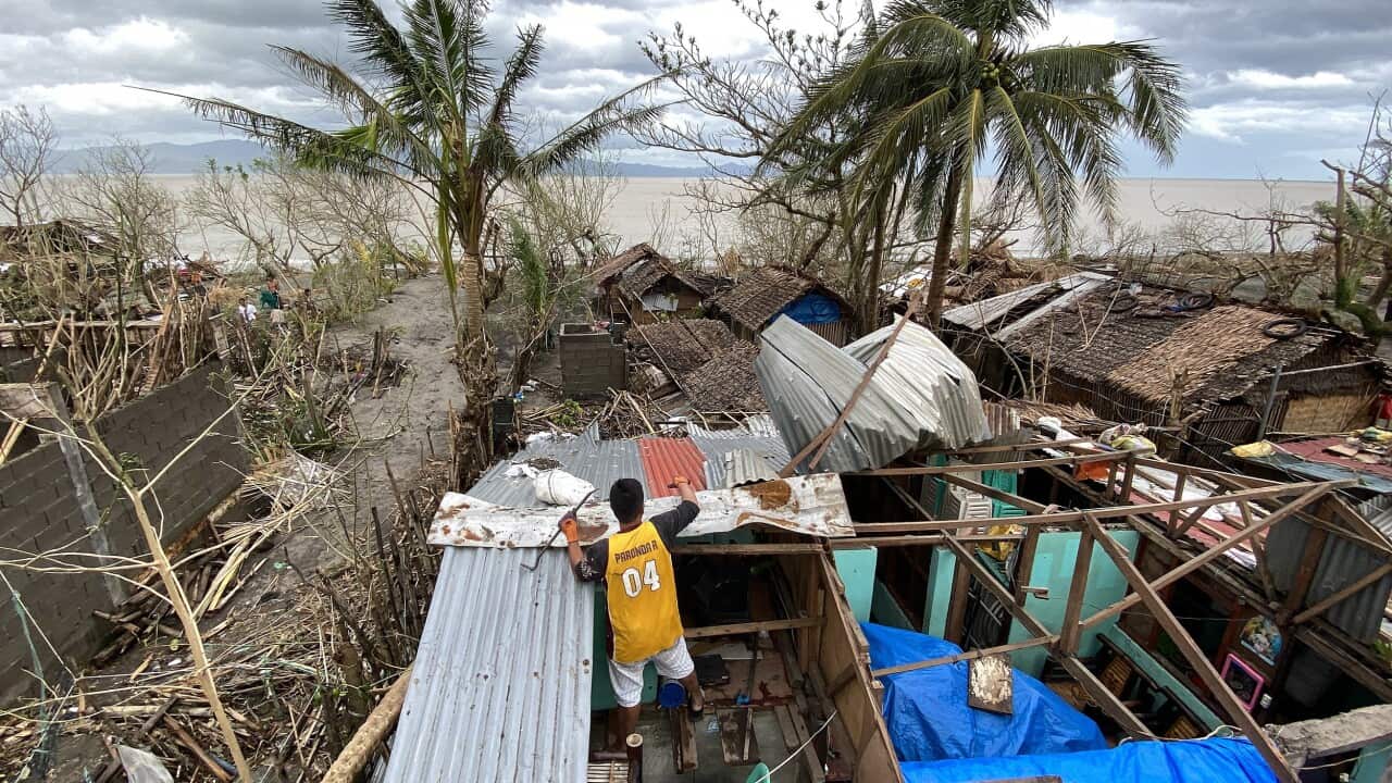 A Filipino villager repairs a damaged home in the typhoon-hit country, 1 November 2020.
