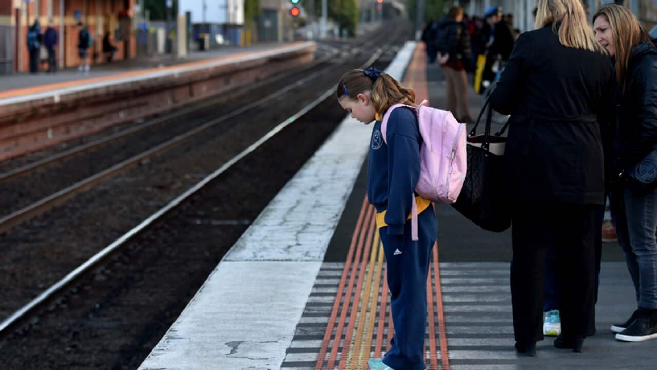 A schoolgirl at a Melbourne train station