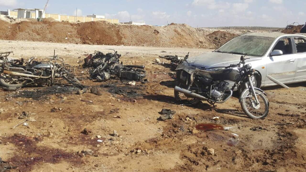 Burned motorcycles and car that damaged after a suicide attack