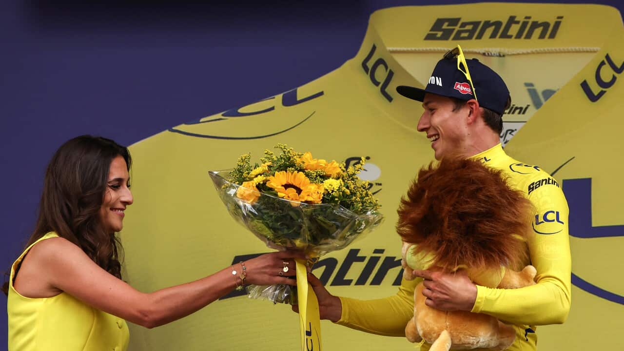 Belgian rider Jasper Philipsen celebrates on the podium