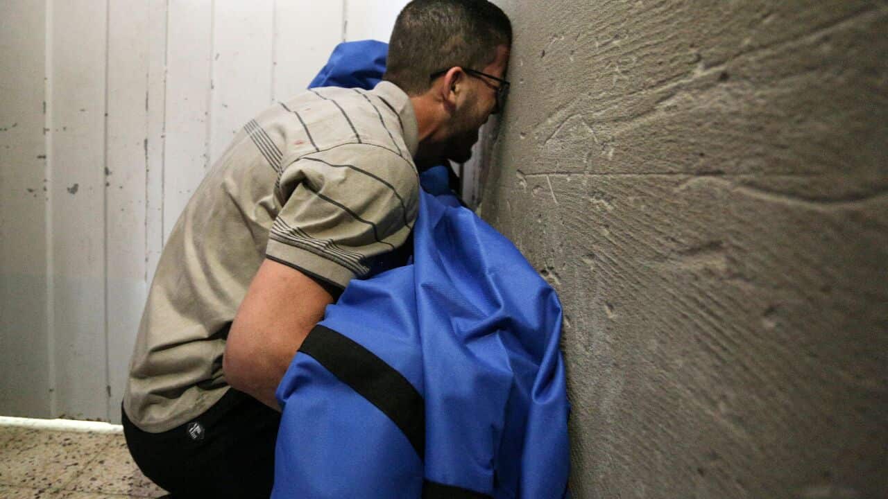 The father of 12-year-old Rahaf al-Dayer holds her covered body at al-Shifa hospital, after she was killed in an Israeli airstrike in Gaza City, 17 May, 2021.