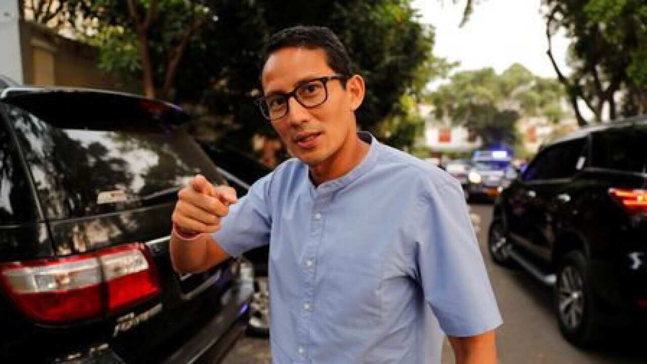 Indonesian vice president candidate Sandiaga Uno gestures as he walks in front of his house in Jakarta.
