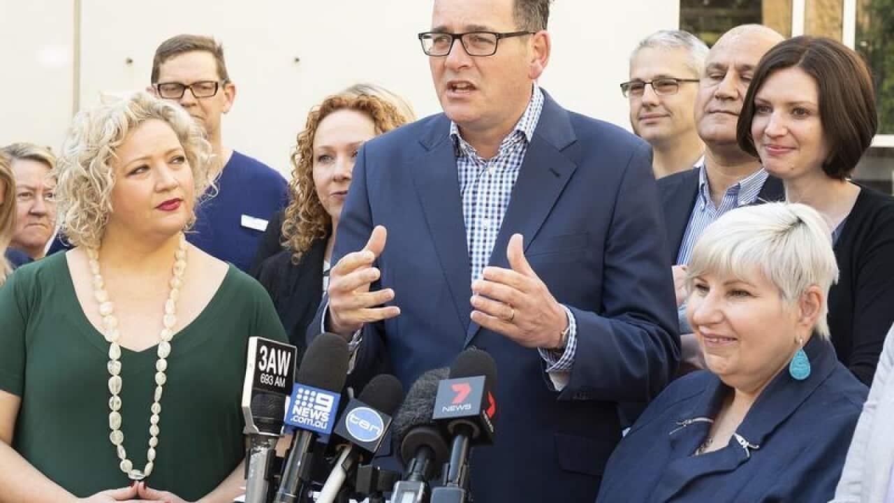 Victorian Premier Daniel Andrews (C) speaks to the media in Footscray.