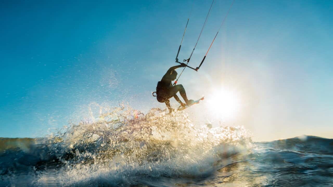 Surfer jumping at the sunset