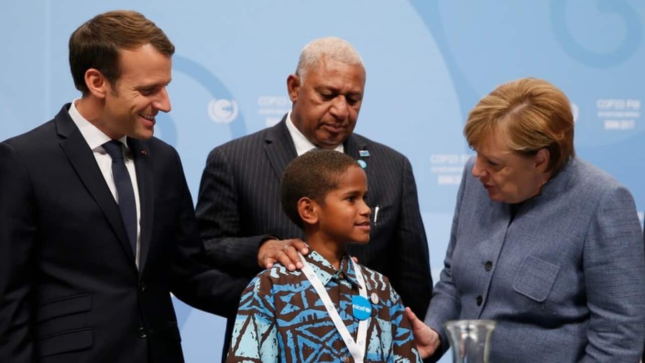 Timothy Naulusala is with (L-R) French President Emmanuel Macron, Fiji PM Frank Bainimarama and German Chancellor Angela Merkel