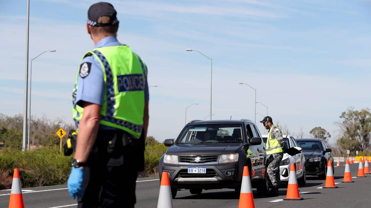 Police officers and Royal Australian Navy personnel are seen stopping drivers in WA