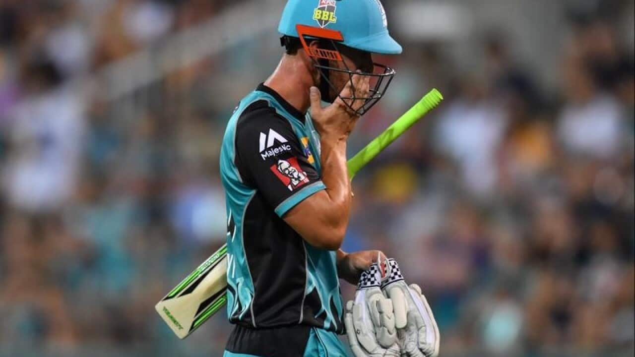 Chris Lynn of the Heat walks off the field after losing his wicket